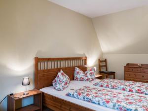 a bedroom with two beds and a dresser at Attractive Apartment in Quedlinburg in Quedlinburg