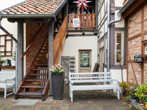 a building with two benches and a balcony at Attractive Apartment in Quedlinburg in Quedlinburg