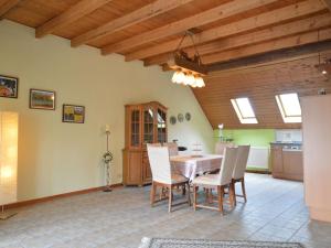 a kitchen and dining room with a table and chairs at Roofed Farmhouse in Juchen with private terrace and garden in Jüchen
