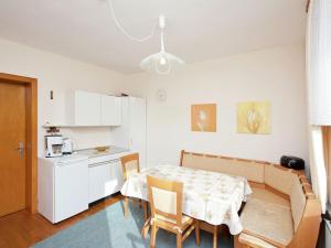 a kitchen and a dining room with a table and chairs at Cozy Holiday Home in Wallenborn with Garden in Wallenborn