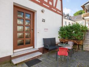 a patio with chairs and a table in front of a house at Wohnung in Battenberg nahe Winterberg Skigebiet in Battenberg