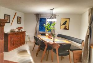 a dining room table and chairs in a room at Schwendi Maison in Mels