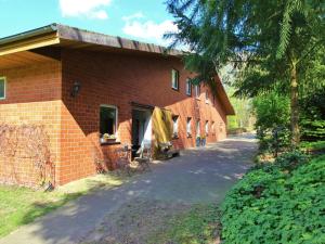 a red brick building with a fence around it at Apartment in Kirchdorf with Swimming Pool Garden Terrace in Kirchdorf