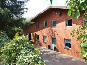 a red brick building with windows and a driveway at Apartment in Kirchdorf with Swimming Pool Garden Terrace in Kirchdorf