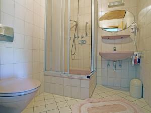 a bathroom with a toilet and a sink and a shower at Charming Apartment with Balcony Garden BBQ Parking Heating in Schmallenberg