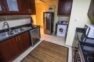 a small kitchen with a sink and a refrigerator at 2 Bedroom Apartment - JBR in Dubai