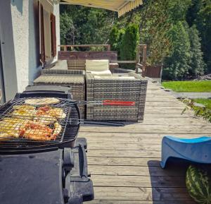 a grill on a deck with some food on it at Schwendi Maison in Mels