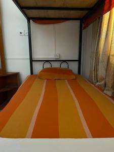 Postel nebo postele na pokoji v ubytování Sea Sands Beach Hostel