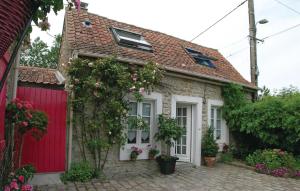 a red and white house with a red garage at Cozy Home In Ambleteuse With Wifi in Ambleteuse +12 photos