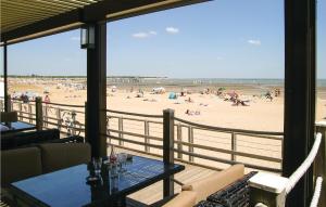 a balcony with a view of a beach with people at Three-Bedroom Holiday Home In La Tranche Sur Mer in La Tranche-sur-Mer