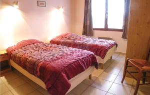 two beds in a room with a window at Three-Bedroom Holiday Home In La Tranche Sur Mer in La Tranche-sur-Mer