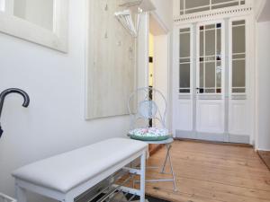 a white bench in a room with a door at ground floor apartment in Blankenburg in Blankenburg