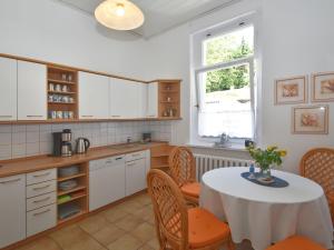 a kitchen with a table and chairs and a window at ground floor apartment in Blankenburg in Blankenburg