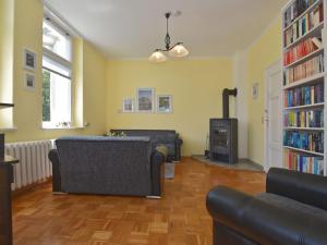 a living room with two couches and a fireplace at ground floor apartment in Blankenburg in Blankenburg