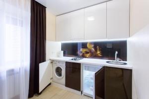 a kitchen with a sink and a washing machine at Luxury One bedrooms 23 August in Kharkiv