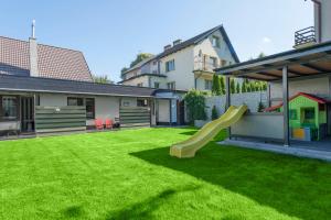 a yard with a playground with a slide at Domy Rafa Ustka in Ustka