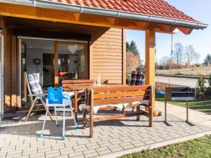 ハッセルフェルデにあるHoliday home in Hasselfelde with gardenのパティオ(木製ベンチ、テーブル、椅子付)