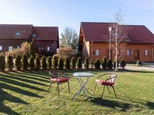 two chairs and a glass table in a yard at Holiday home in Hasselfelde with garden in Hasselfelde