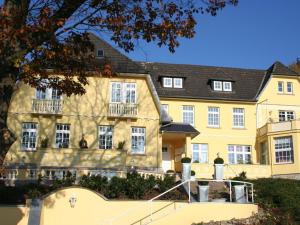 a yellow building with a staircase in front of it at Villa with a view of the Weserbergland in Bad Pyrmont