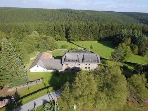 an aerial view of a large house in a field at Luxurious Holiday Home in Kalterherberg with Sauna in Alzen