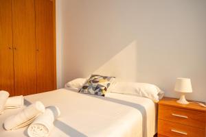 A bed or beds in a room at Cap Blanc Penthouse Cullera