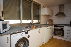 A kitchen or kitchenette at Cap Blanc Penthouse Cullera