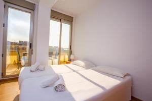 A bed or beds in a room at Cap Blanc Penthouse Cullera