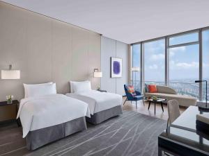 Uma cama ou camas num quarto em Niccolo Suzhou