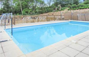 a blue swimming pool with a wooden fence at Cozy Apartment In Alette With Wifi in Alette +20 photos