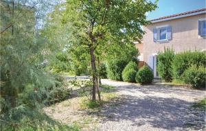 a tree in the yard of a house at Cozy Home In Calvisson With Kitchen in Calvisson