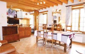 a kitchen and dining room with a table and chairs at Nice Home In Morsalines With 2 Bedrooms And Wifi in Morsalines