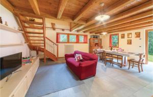 ein Wohnzimmer mit einem roten Sofa und einem Tisch in der Unterkunft Pian Del Lac in Sovramonte