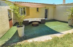 a patio with a couch and a potted plant at La Bastide in Grignan