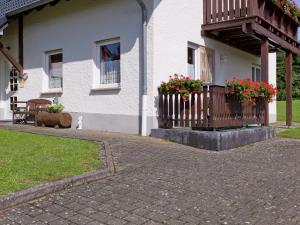 a house with two flower boxes on a balcony at Modern Apartment in Bolsdorf with Sauna in Dohm-Lammersdorf