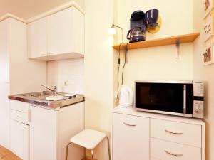 a small kitchen with a sink and a microwave at Modern Apartment in Bolsdorf with Sauna in Dohm-Lammersdorf