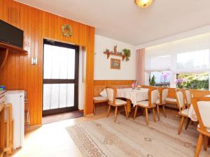 a dining room with a table and chairs at Modern Apartment in Bolsdorf with Sauna in Dohm-Lammersdorf