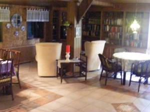 a room with a table and chairs in a library at Holiday home in Herzlake with garden in Herzlake
