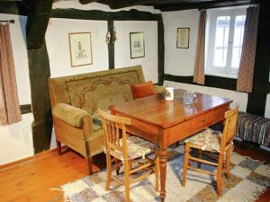a dining room with a wooden table and chairs at Holiday home in Hesse with garden in Willingshausen