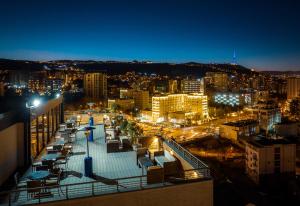a view of a city at night with lights at Reed Hotel Tbilisi in Tbilisi City