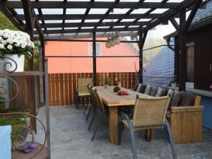 a wooden table and chairs on a patio at Holiday home in nice surrounding in Veldenz