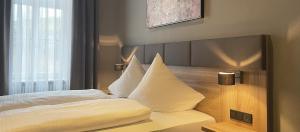Postel nebo postele na pokoji v ubytování Hotel Das Bischof