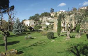 a green yard with trees and houses on a hill at Amazing Apartment In Oletta With Kitchen in Oletta