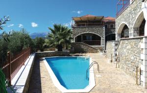 a swimming pool in front of a house at 3 Bedroom Lovely Home In Paralio Astros in Koútroufa