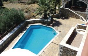 a swimming pool in the middle of a yard at 3 Bedroom Lovely Home In Paralio Astros in Koútroufa