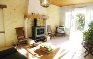 a living room with a fireplace and a stove at Beautiful Home In La Jonchere in La Jonchère