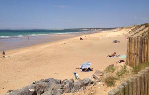 a group of people on a beach near the ocean at Beautiful Home In La Jonchere in La Jonchère +13 photos