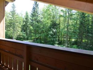 a window in a cabin looking out at the forest at Cosy apartment in Sch nau am K nigsee with balcony in Schönau am Königssee