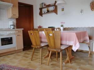 eine Küche mit einem rosa Tisch und Stühlen in der Unterkunft Panoramic view Apartment in Baiersbronn with Garden in Baiersbronn