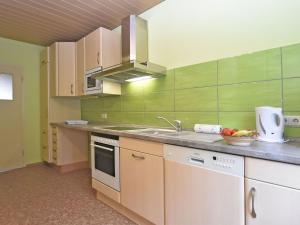 a kitchen with a sink and a counter top at Apartment with panoramic view in Brotterode-Trusetal