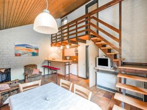 a kitchen and living room with a table and a staircase at Ferienhaus mit herrlicher Aussicht in Schmallenberg